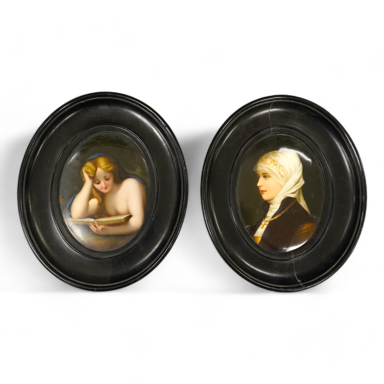 A pair of mid 19th century Paris porcelain plaques decorated with portraits of female figures, both in oval ebonised frames. Condition - fair to good